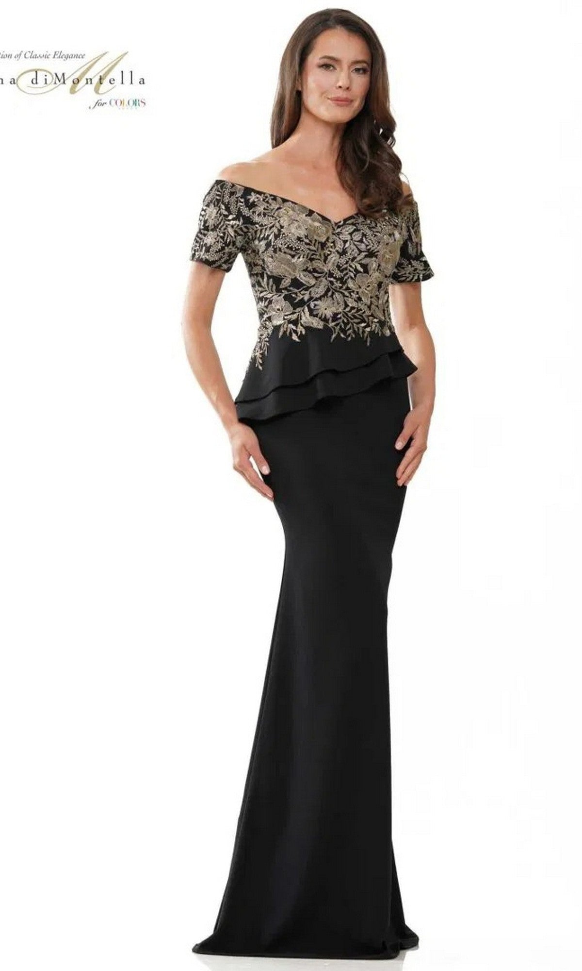 A woman models the Long Formal Dress: Rina Di Montella RD2918 in black, featuring gold floral embroidery and peplum detail, against a plain white background.